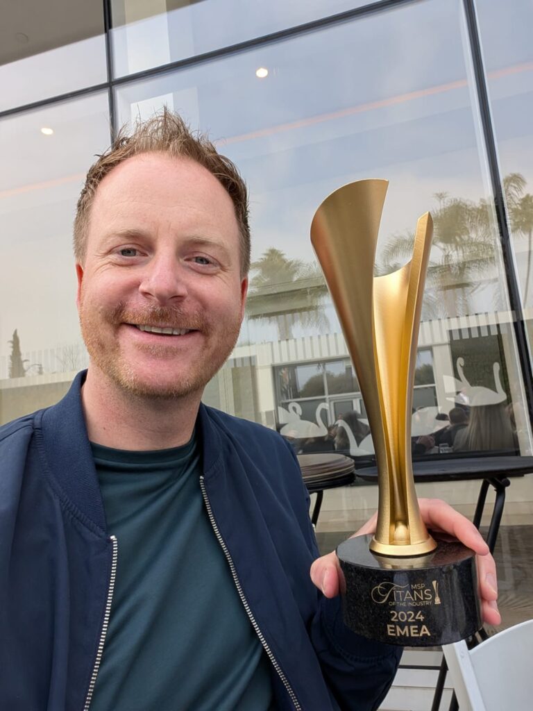 Ian holding an award